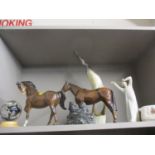 A horn model of a heron, a Lladro figure, a Canadian figural group, two Beswick mares, a signed
