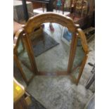 A modern American oak triptych mirror with carved ornament