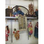 A quantity of Asian puppets, fabrics, a Thai carved treen figure, a hardwood box, a carved panel,