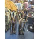 Two stick stands containing mixed umbrellas and walking sticks to include one having an ivory top