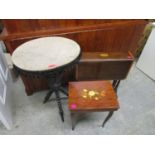 A Victorian ebonized gypsy table with fabric lined circular top having pendant tassels, an Edwardian