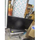 A mixed lot to include an LG 32" TV, Freeview box, aerial, fan, dustpan and brush, microwave,