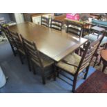 An oak refectory dining table, together with a set of six ladder back chairs and one carver, 29 1/2"