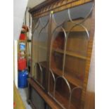 A reproduction mahogany large display cabinet having a moulded cornice above two glazed doors and