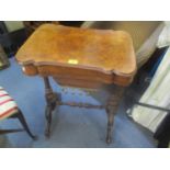 A Victorian walnut work table with a rotating top, revealing a scriber above a wool-well, on