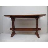 A David Oakleafman Langstaff mahogany refectory style coffee table, with vase shaped ends, on shaped