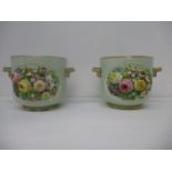 A pair of late 19th century planters, possibly Minton, encrusted with flowers and foliage on a green