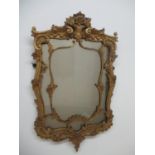 A 19th century gilt wood and gesso framed mirror decorated with flowers, scrolls and foliage, 33"