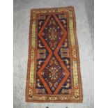 A North Persian rug with two medallions and geometric motifs on a dark blue ground, 88" x 46"