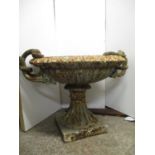 A Victorian cast iron garden planter of shallow urn design with twin opposing entwined swan neck and