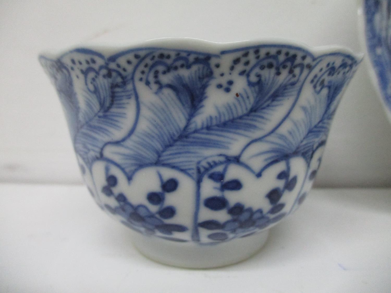 An early 18th century Kangxi blue and white cup and saucer, each with a fared wavy lip, the cup - Image 2 of 6