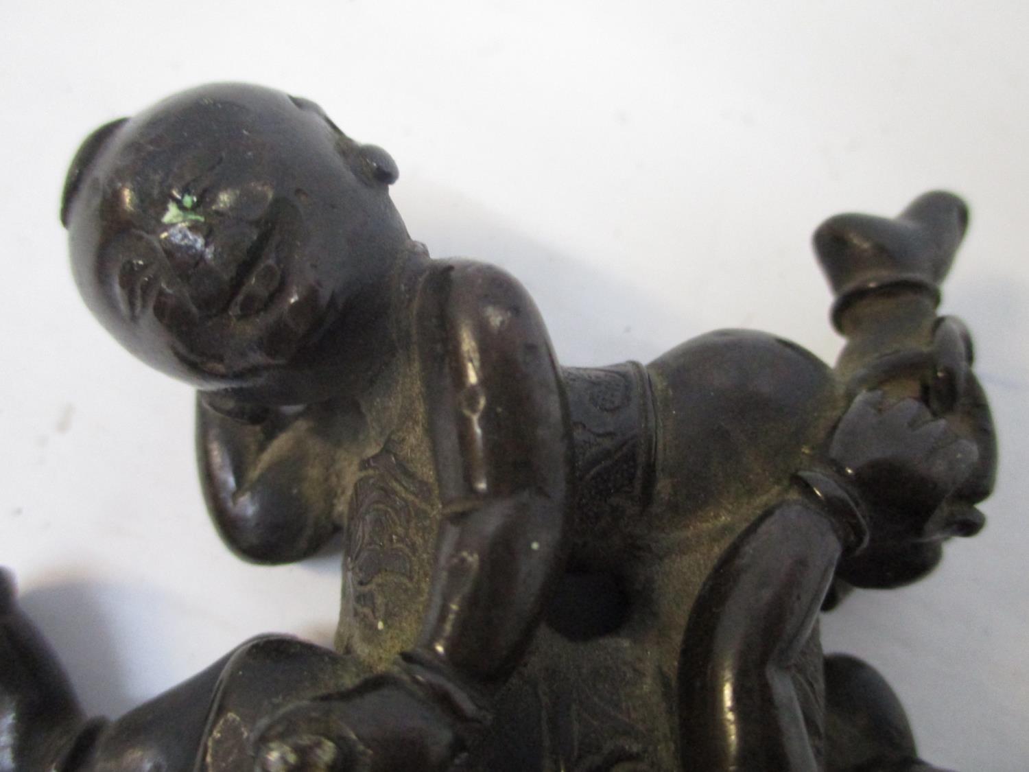 A late 19th century Chinese bronze group of two children head to foot, lying on their sides, 2 1/2"w - Image 3 of 3
