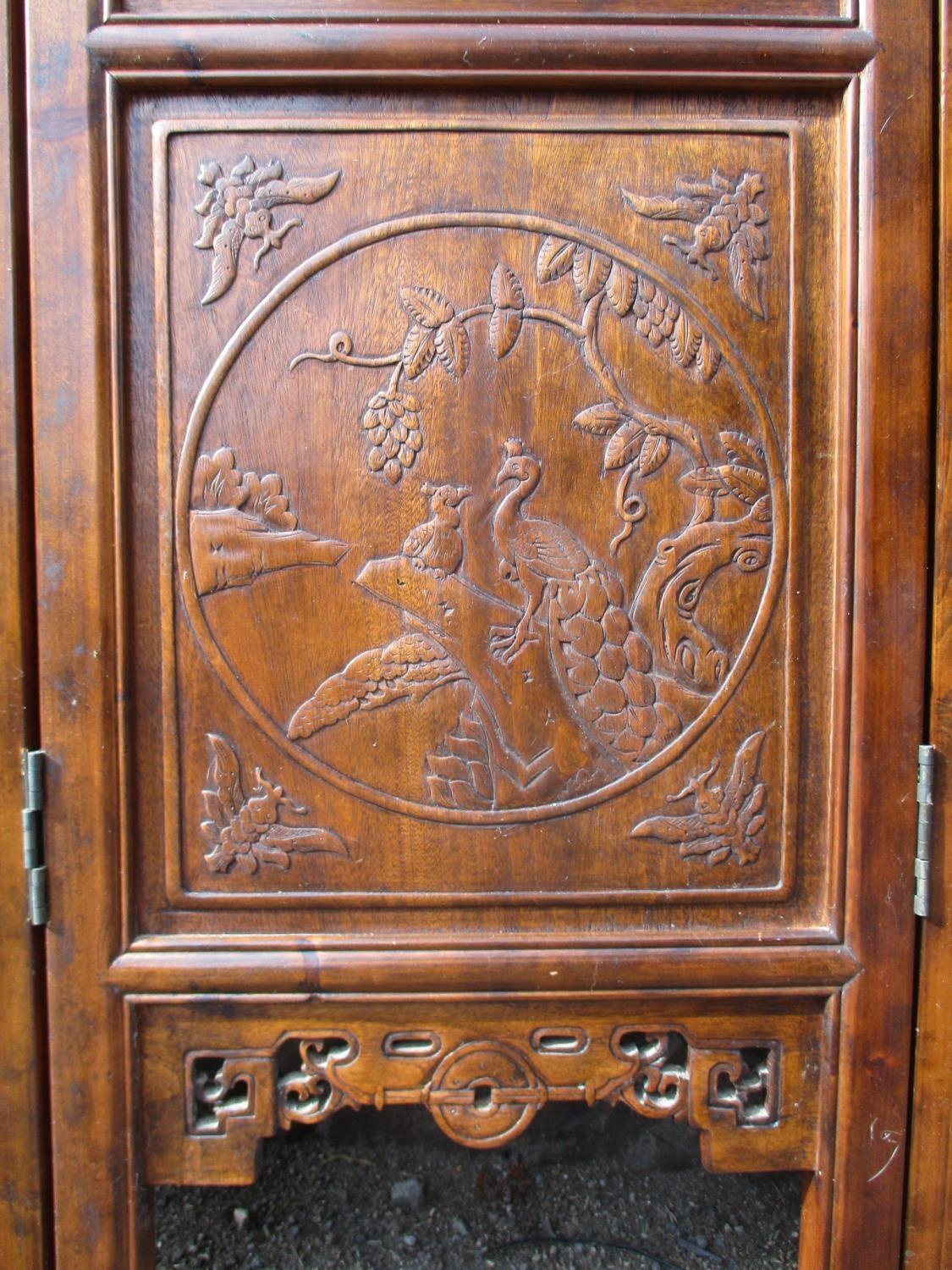 A 20th century Chinese elm four fold screen, with carved and pierced panels, decorated with animals, - Image 7 of 9