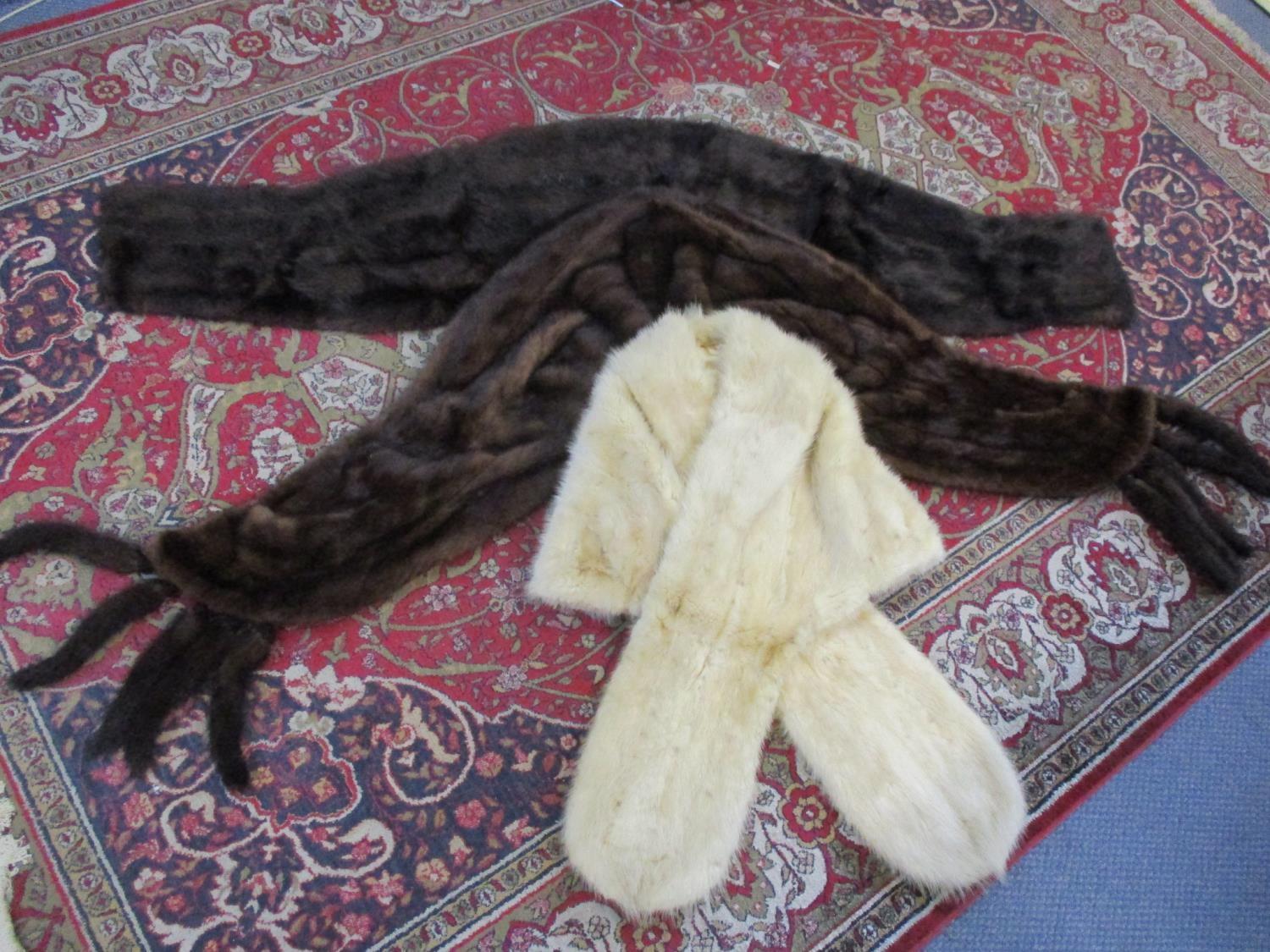 A vintage dark brown mink stole, a vintage dark brown mink wrap with mink tail tassels and an arctic