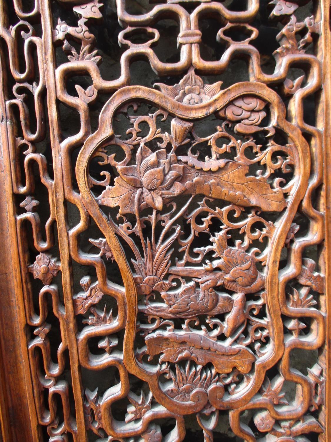 A 20th century Chinese elm four fold screen, with carved and pierced panels, decorated with animals, - Image 5 of 9
