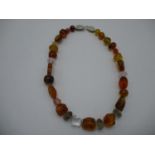 An Ivone Brosch necklace with faceted and irregular amber quartz rock crystal beads