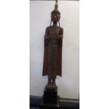 An 18th/19th century Thai carved wooden standing Buddha, the hand gesture suggests they were holding