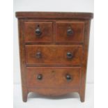 A Victorian traders sample of a walnut chest of two short and two long drawers, with turned handles,