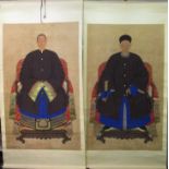 A pair of 20th century Chinese ancestral portraits of a man and woman sat in a throw covered chair