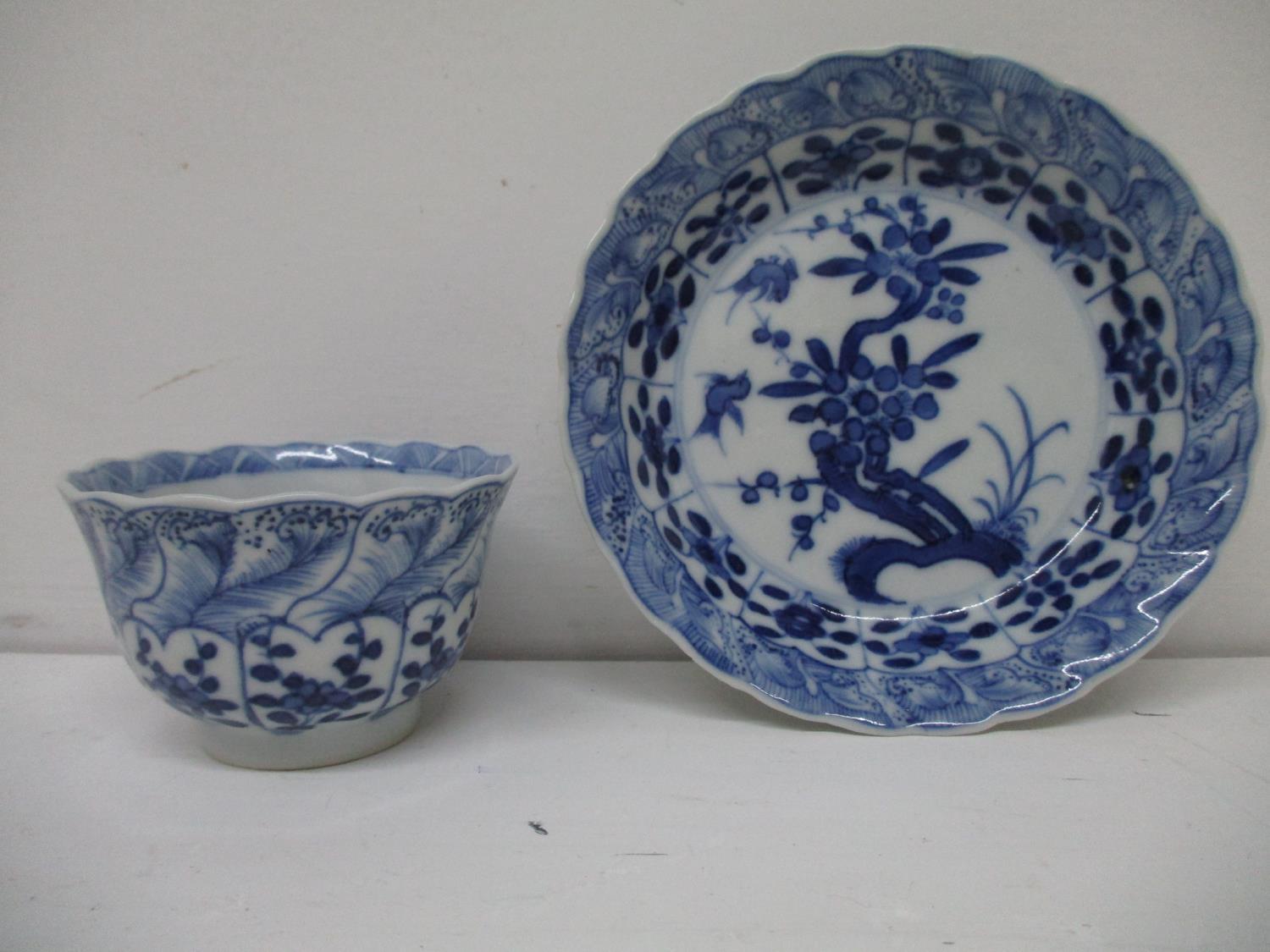 An early 18th century Kangxi blue and white cup and saucer, each with a fared wavy lip, the cup