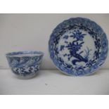 An early 18th century Kangxi blue and white cup and saucer, each with a fared wavy lip, the cup