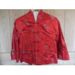 A mid to late 20th century Chinese red silk jacket decorated in flowers and bamboo leaves, 36" chest