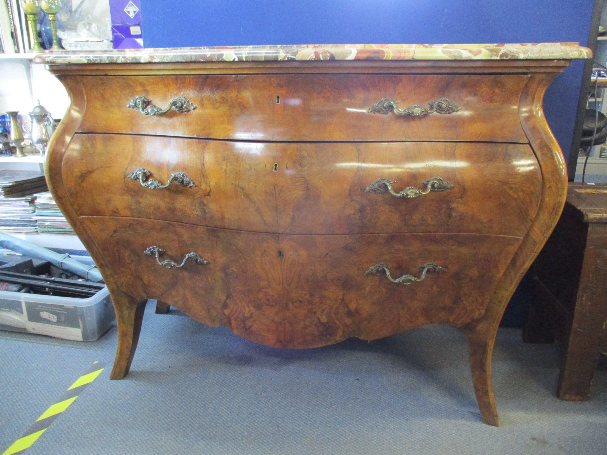 A late 20th century reproduction of a Louis IV walnut bombe commode with a mottled marble top over