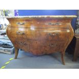 A late 20th century reproduction of a Louis IV walnut bombe commode with a mottled marble top over