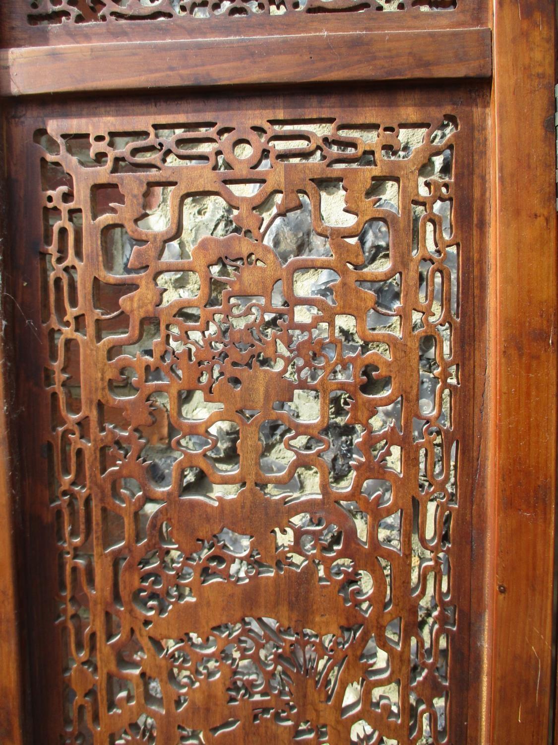 A 20th century Chinese elm four fold screen, with carved and pierced panels, decorated with animals, - Image 9 of 9