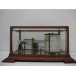 An Edwardian barograph with eight discs and lacquered brass parts, a clear glass ink bottle and a