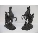 A pair of late 19th century cast bronze model Marley horses, each on a naturalistic base, one