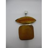 An Ivone Brosch silver pendant set with amber, fashioned as a conjoined lozenge and square, 3 3/4" x