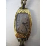 A Victorian 18ct gold cased ladies wristwatch with an engraved, bowed case, a Tavannes & Co movement
