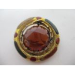 A yellow coloured metal plaid brooch set with a smokey quartz, within an engraved ring set with
