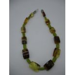 An Ivone Brosch necklace with rectangular amber and facet cut jadeite beads and a silver clasp