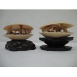 Two late 19th century Chinese carved ivory clam shells each with figures working under trees, one