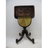 A Regency mahogany work table with twin fall flaps, over two drawers, the upper one with a lined