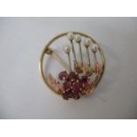 A 9ct gold brooch set with rubies and pearls, fashioned as flowers, 5.3g