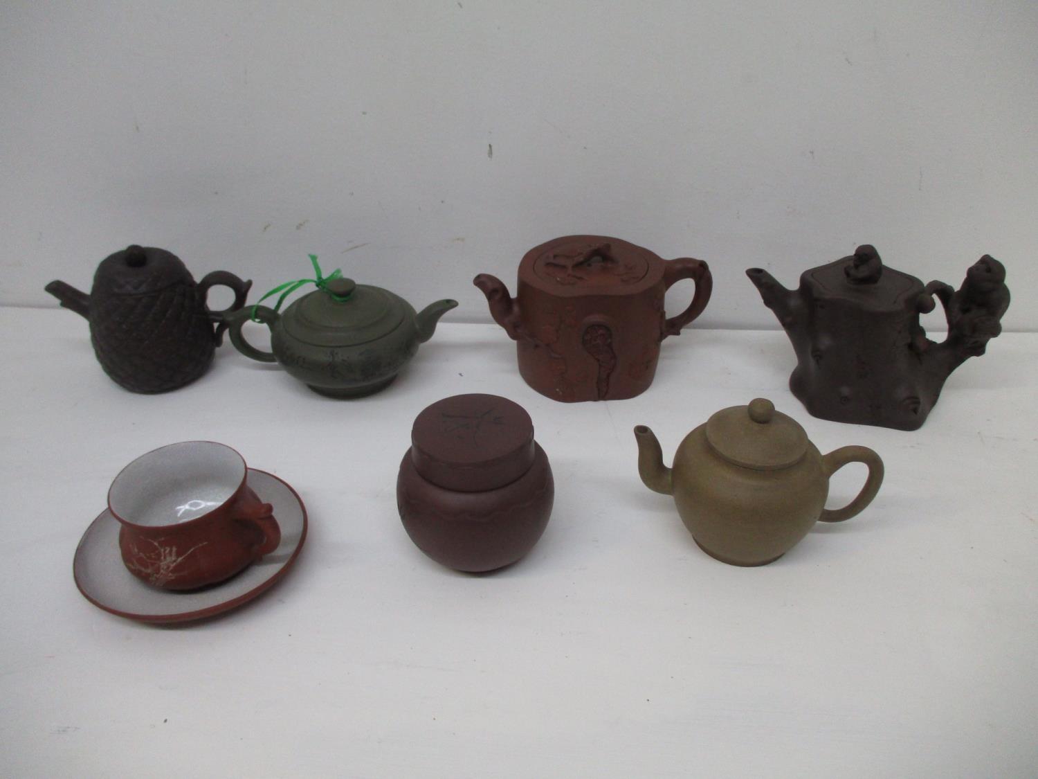 A group of Chinese Yixing Zisha pottery teapots, a pot and cover and a tea cup and saucer to include