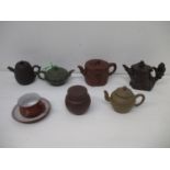 A group of Chinese Yixing Zisha pottery teapots, a pot and cover and a tea cup and saucer to include