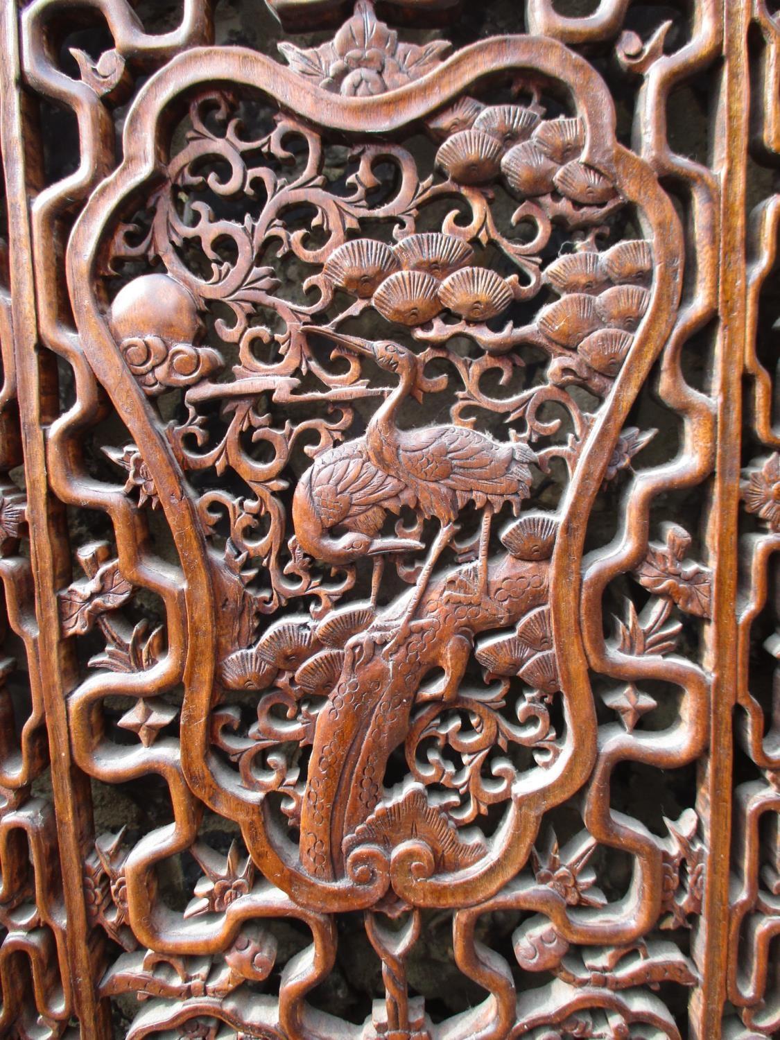 A 20th century Chinese elm four fold screen, with carved and pierced panels, decorated with animals, - Image 4 of 9