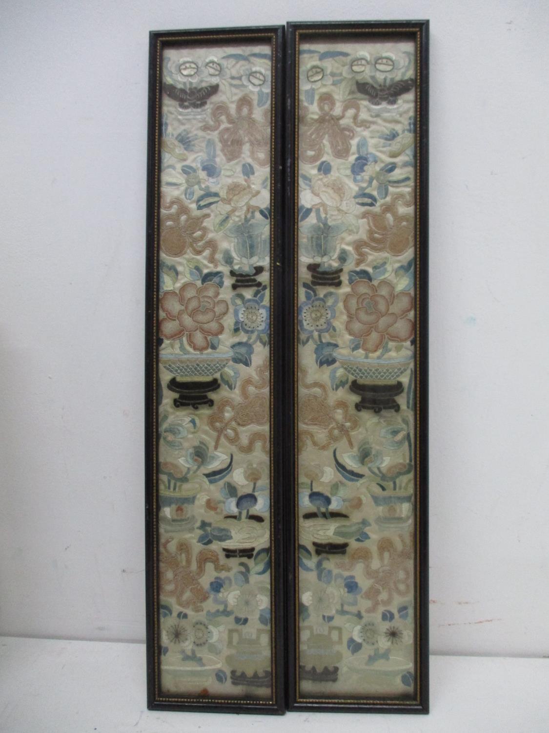 A pair of 19th century Chinese embroidered silk panels with flowers plants objects and bowls each