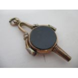 A 9ct gold rotating fob watch key set with two stone tablets, on a frame and suspension ring, 9g