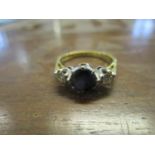 An 18ct yellow gold sapphire and diamond three stone ring