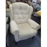 A modern button wingback armchair