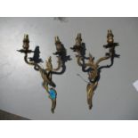 A pair of metal wall lights with scrolled ornament