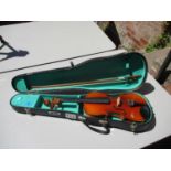 A Lark Chinese violin with a bow in a carrying case