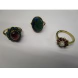 Three 9ct gold rings, one set with a moon stone and garnets, another with turquoise surrounding a