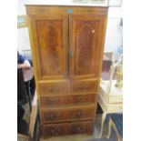 An early 20th century walnut converted section of a wardrobe having two cupboard doors and drawers