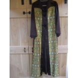 An Asian brown satin full length coat having two front panels and the back embroidered with multi
